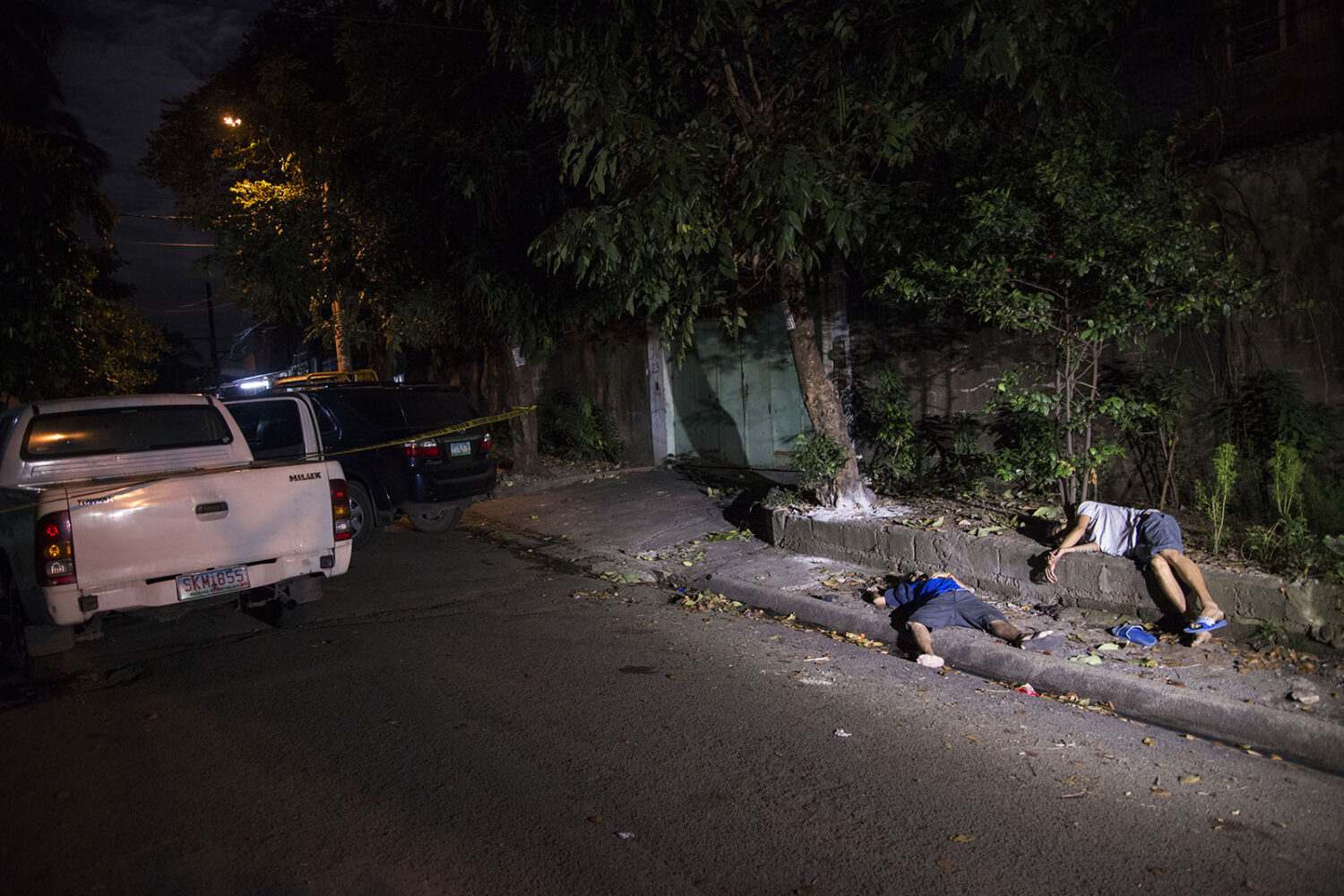The bodies of Charlie Lorenzo and Telemacus Esmilla, killed during a police buy-bust operation in Quezon City, Metro Manila. 