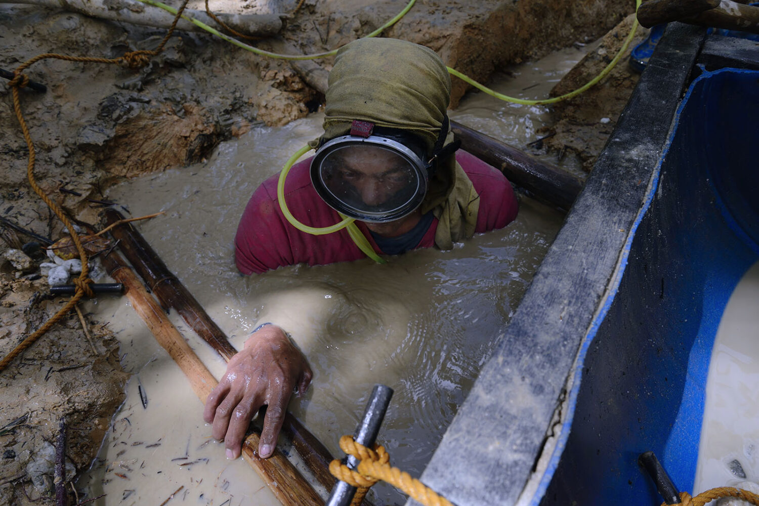 Diver coming up from being underwater in the muddy pit for more than 3hours.